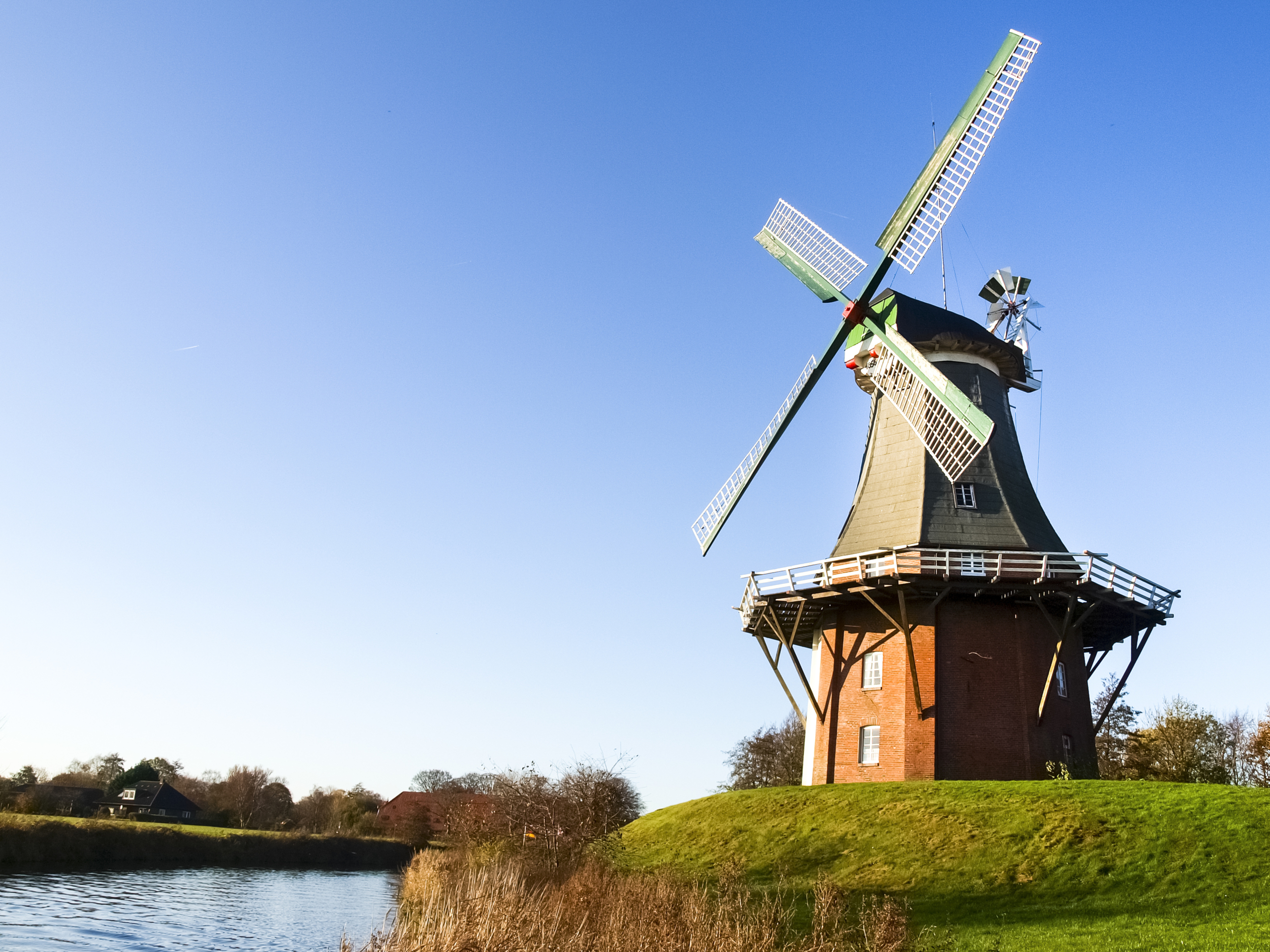 Historische Windmühle an einem Flussufer